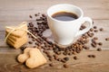 The cup of coffee, coffee beans and cookies-hearts related together Royalty Free Stock Photo