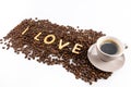 Cup of coffee and coffee beans with cookies in shape of Love word Royalty Free Stock Photo