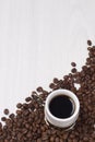 Cup of coffee with coffee beans on white background