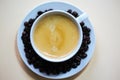 Cup of coffee with coffeebeans on white background