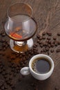 Cup of coffee, cognac glass and coffee beans