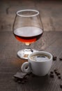 Cup of coffee, cognac glass and coffee beans