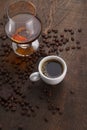 Cup of coffee, cognac glass and coffee beans