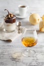 Cup of coffee, cognac glass and coffee beans on a wooden table