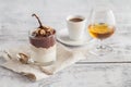 Cup of coffee, cognac glass and coffee beans on a wooden table