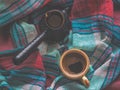 A Cup of coffee and colored textiles. Comfort on cold days. Home comfort. Royalty Free Stock Photo