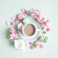 Cup of coffee with colorful macaron or macaroon cakes