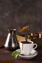 Cup of coffee with cooffee beans, wooden box with grains of coffee and spices, cezve on a stone background Royalty Free Stock Photo