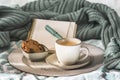 Cup of coffee and cookie on cozy bed. Warm wool sweater for a cozy autumn weekend, breakfast in bed, coffee break. Hygge concept Royalty Free Stock Photo