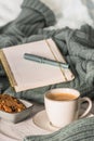 Cup of coffee and cookie on cozy bed. Warm wool sweater for a cozy autumn weekend, breakfast in bed, coffee break. Hygge concept Royalty Free Stock Photo