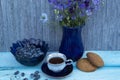 a cup of coffee, cookies, honeysuckle berries and a bouquet of flowers Royalty Free Stock Photo