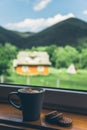 Cup of coffee with cookies on windowsill