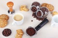 Cup of coffee, crackers, cookies, holder with ground coffee, tamper and cans of coffee beans on table Royalty Free Stock Photo