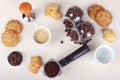 Cup of coffee, crackers, cookies, holder with ground coffee, tamper and cans of coffee beans on table. View from above Royalty Free Stock Photo