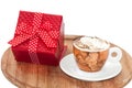 A cup of coffee with cream and red gift box with bow Royalty Free Stock Photo
