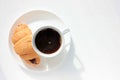 Cup of coffee and croissant on white background. Top view, copy space. Morning espresso on table. Healthy breakfast. Royalty Free Stock Photo