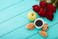 Cup of coffee with croissants, cookies, apple, red roses on blue wooden background. Copy space. Mock up. Top view. Valentine Royalty Free Stock Photo