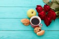 Cup of coffee with croissants, cookies, apple, red roses on blue wooden background. Copy space. Mock up. Top view. Valentine Royalty Free Stock Photo