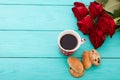 Cup of coffee with croissants and cookies and red roses on blue wooden background. Copy space. Mock up. Top view. Valentine Royalty Free Stock Photo