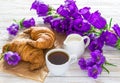 Cup of coffee, croissants, milk jar and lilac flowers Royalty Free Stock Photo