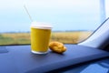 a cup of coffee and curasan in the car Royalty Free Stock Photo