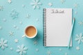 Cup of coffee, decorative snowflakes and notebook with to do list on turquoise background top view, Christmas and winter planning