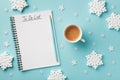 Cup of coffee, decorative snowflakes and notebook with to do list on turquoise background top view, Christmas and winter planning