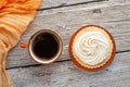 cup of coffee with delicious cream cake with orange scarf around white old style wooden background. close up. lifestyle concept Royalty Free Stock Photo