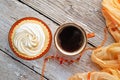 cup of coffee with delicious cream cake with orange scarf around white old style wooden background. close up. lifestyle concept Royalty Free Stock Photo