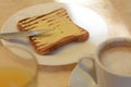 Cup of coffee and delicious sandwich with butter on beige table, closeup Royalty Free Stock Photo
