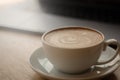 A cup of coffee on desk, Cup of coffee in hand, mug of latte coffee, Close up concept