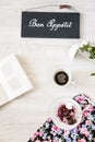 Cup of coffee with dessert and book on the table Royalty Free Stock Photo