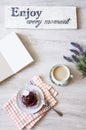 Cup of coffee with dessert and notebook on the table Royalty Free Stock Photo