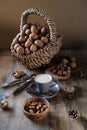 Cup of coffee, different kinds of nuts, walnut, hazelnuts, almonds on old wooden table boards, edible seed kernels, food concept, Royalty Free Stock Photo