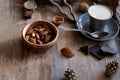 Cup of coffee, different kinds of nuts, walnut, hazelnuts, almonds on old wooden table boards, edible seed kernels, food concept, Royalty Free Stock Photo
