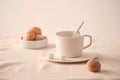 Cup of coffee with donuts for breakfast on light background