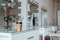 A cup of coffee on dressing table near mirror in makeup room Royalty Free Stock Photo