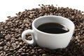 Cup of coffee drink sitting on a bed of roasted coffee beans background. Royalty Free Stock Photo