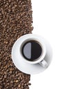 Cup of coffee drink on white table half filled with roasted coffee beans background. Royalty Free Stock Photo