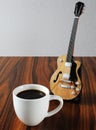 Cup of coffee with eletric guitar miniature Royalty Free Stock Photo