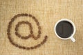 Cup of coffee and email sign. Royalty Free Stock Photo