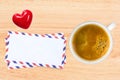 Cup of coffee and envelops on wooden table