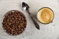 Cup with coffee espresso, bowl with coffee beans, spoon on table. Top view Royalty Free Stock Photo