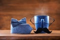 Cup of coffee, eyeglasses, mustache and bowtie for creative breakfast on Happy Fathers Day. Greeting card for daddy