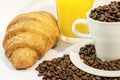 Cup of coffee filed with coffee beans with croissants and orange juice Royalty Free Stock Photo