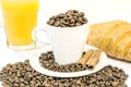 Cup of coffee filed with coffee beans with croissants and orange juice Royalty Free Stock Photo