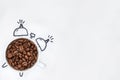 Cup of coffee filled with coffee beans in the shape of an alarm clock on a white background Royalty Free Stock Photo