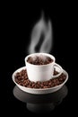 Cup of coffee filled with grains with smoke