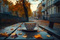 Cup of coffee with floral pattern on bench in autumn courtyard Royalty Free Stock Photo