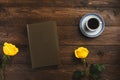 Cup of coffee, flowers, book, isolated on wooden background